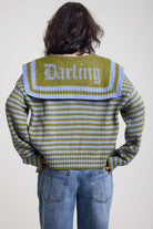 Back image of blue and green stripe knit cardigan with oversized collar with darling motif, worn by a model
