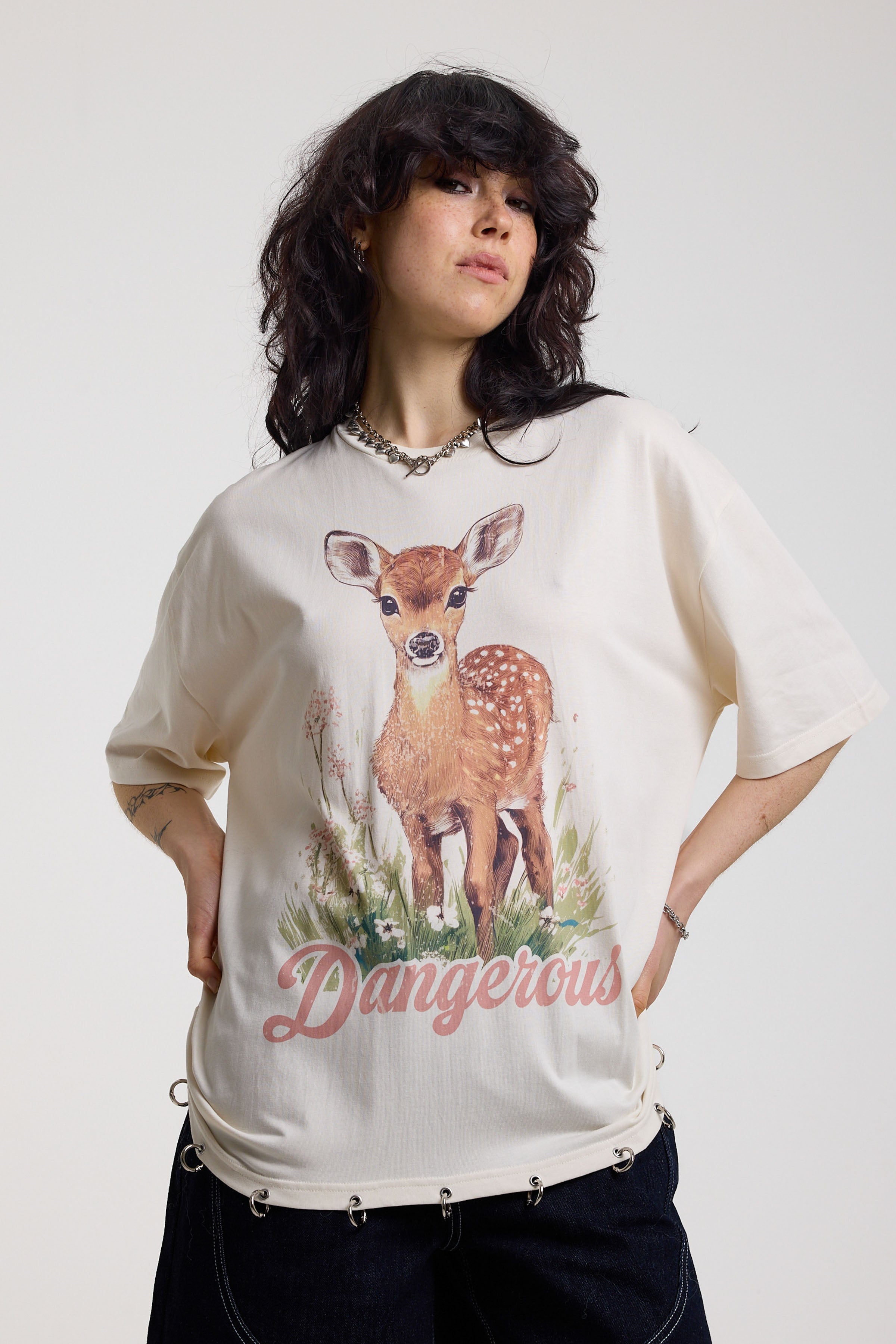 Off-white oversized t-shirt with graphic deer print and silver O-ring hardware detail, worn by model