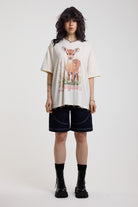 Off-white oversized t-shirt with graphic deer print and silver O-ring hardware detail, worn by model