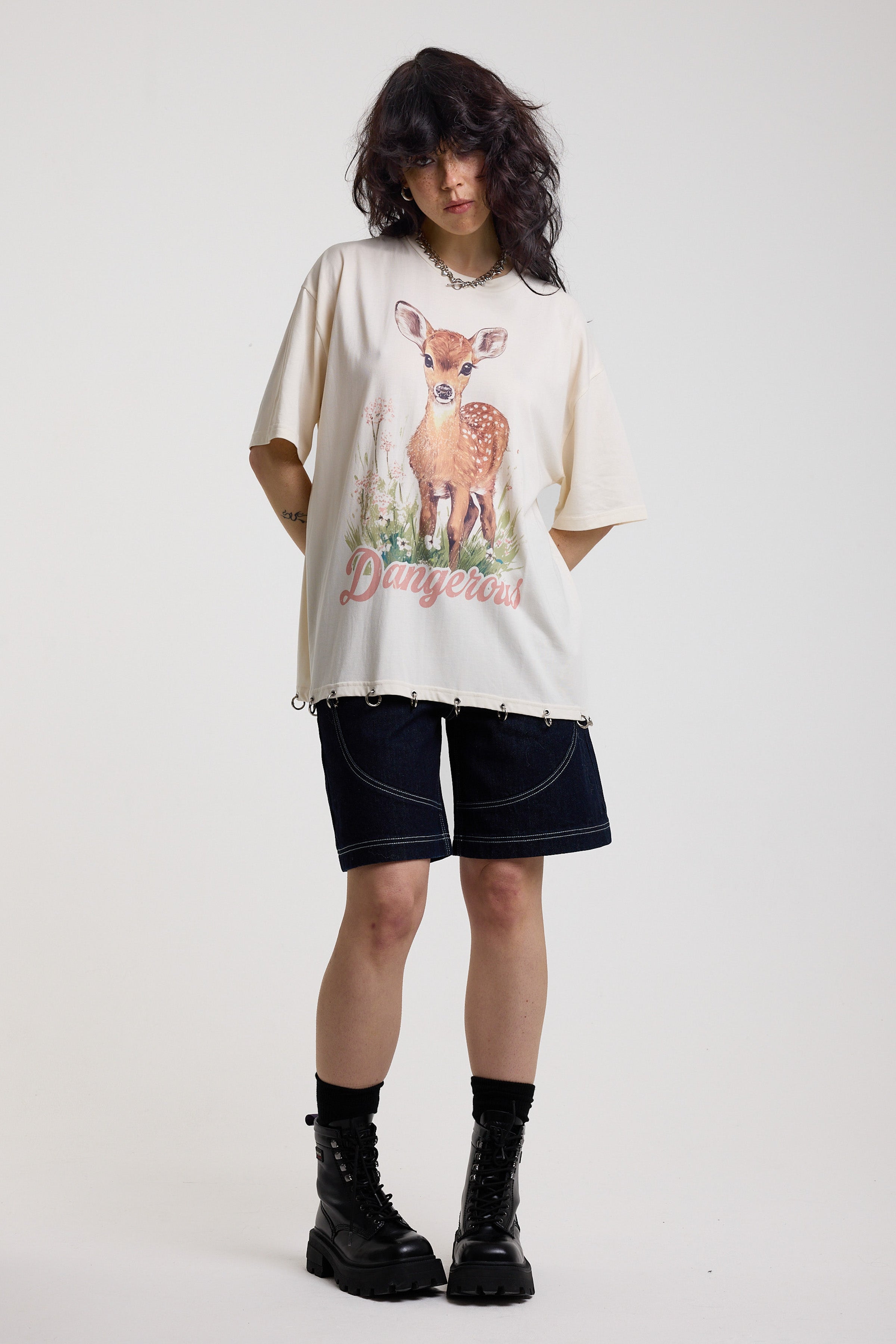 Off-white oversized t-shirt with graphic deer print and silver O-ring hardware detail, worn by model