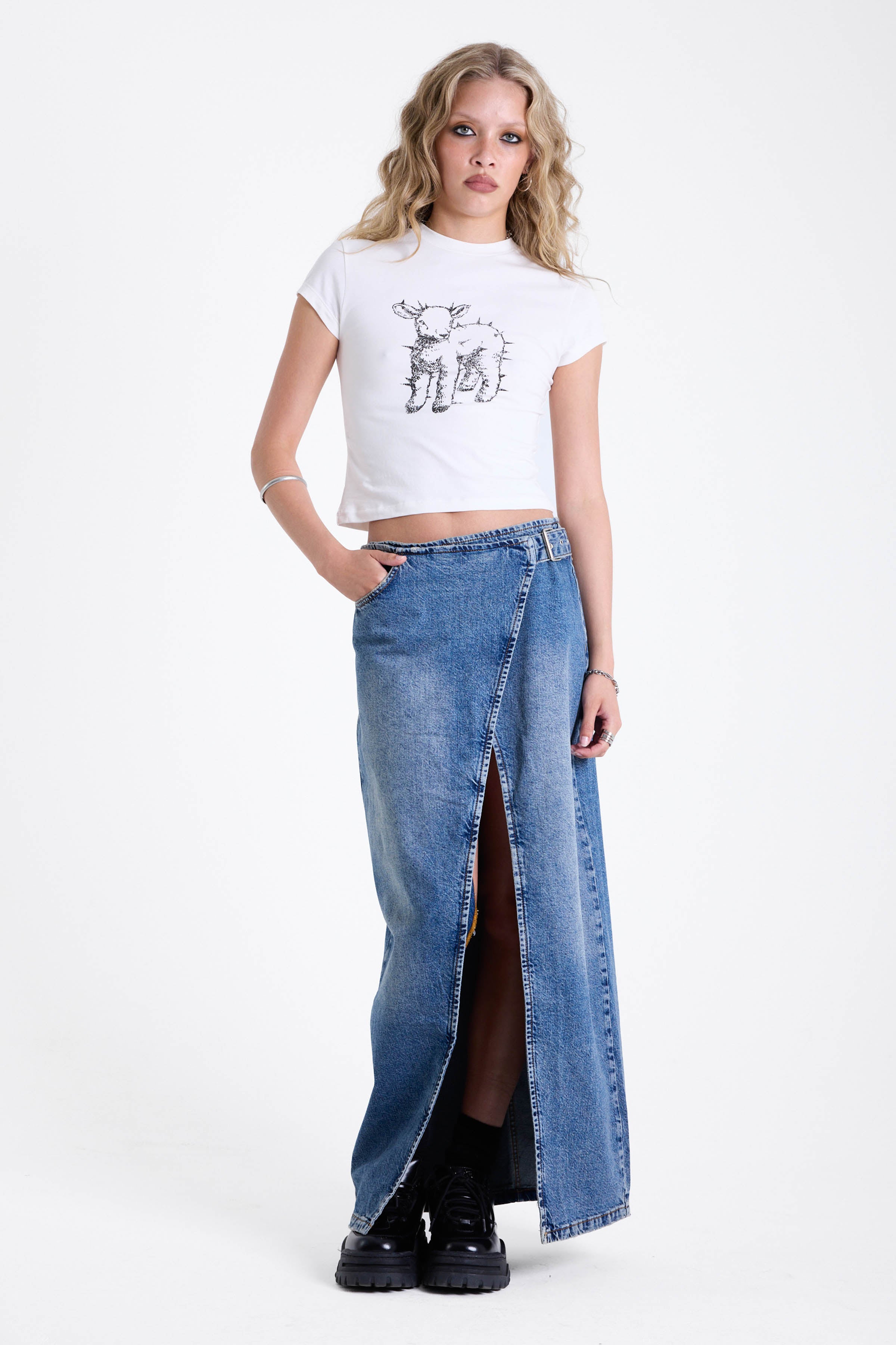 Vintage wash denim maxi skirt with thigh high split and buckle belt fastening, worn by model.