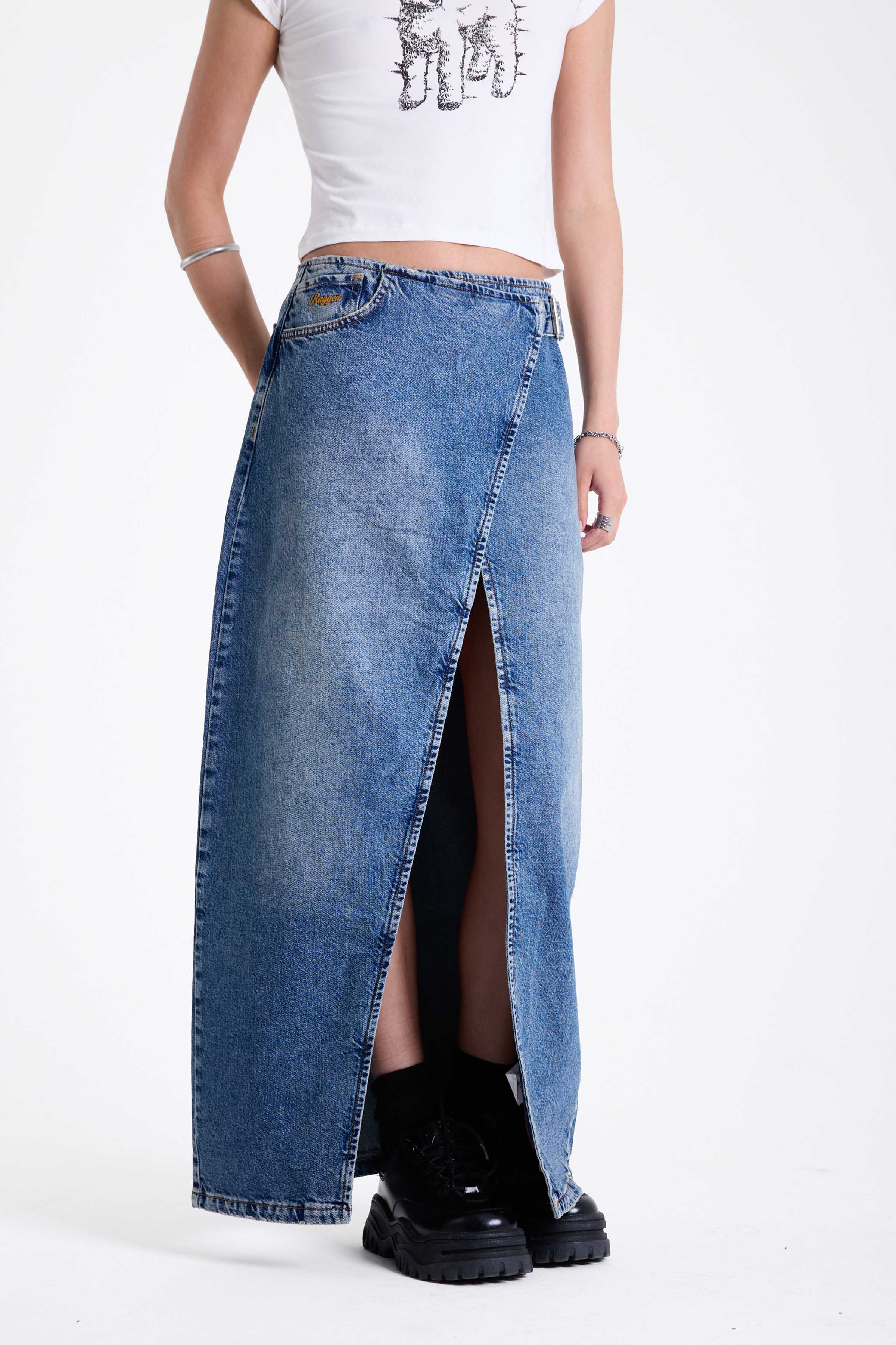 Vintage wash denim maxi skirt with thigh high split and buckle belt fastening, worn by model.