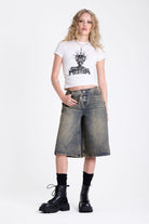 Dirty wash longline oversized denim jorts with no waistband and silver latch clasp detail, worn by model