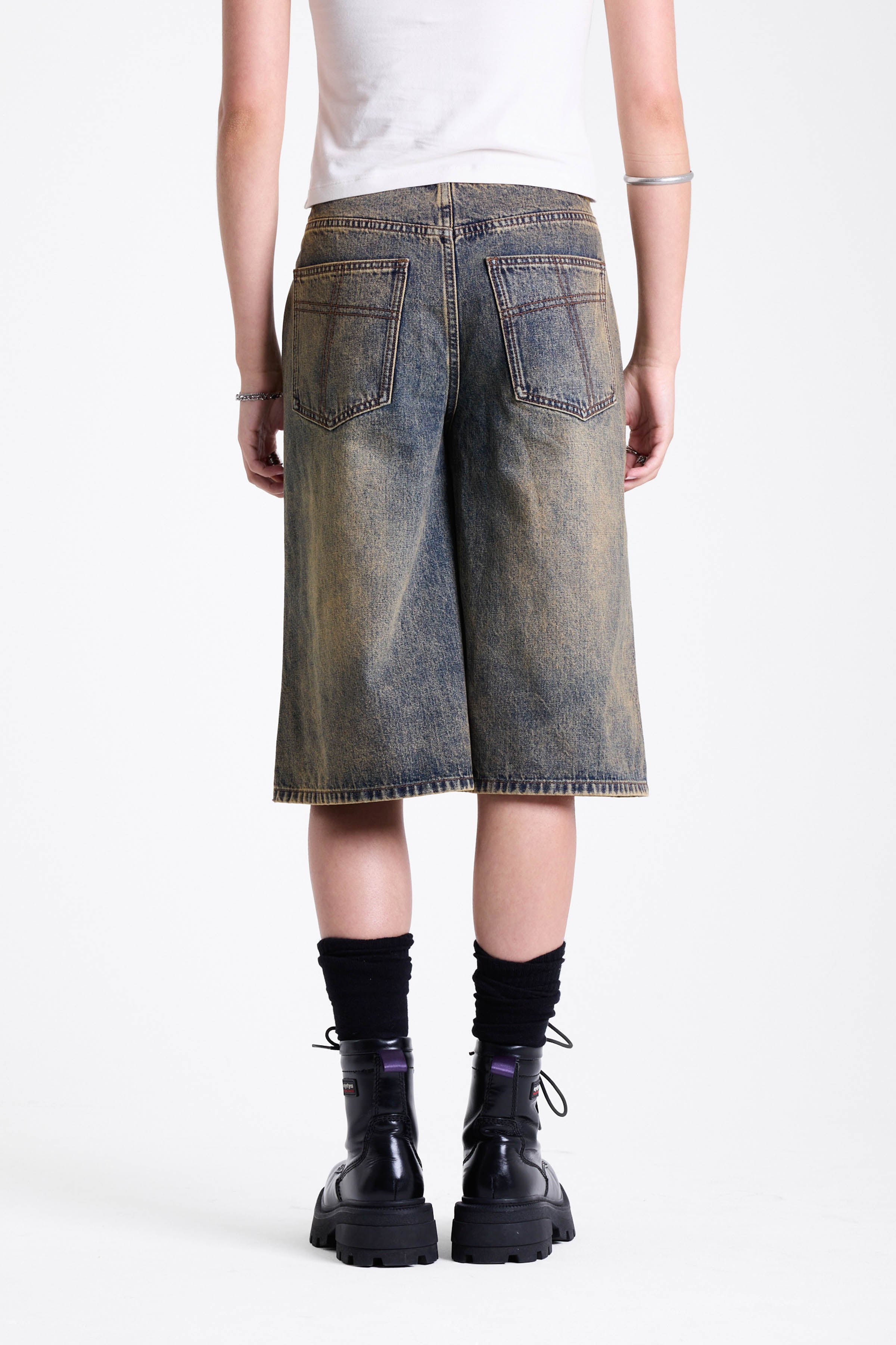 Dirty wash longline oversized denim jorts with no waistband and silver latch clasp detail, worn by model
