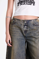 Dirty wash longline oversized denim jorts with no waistband and silver latch clasp detail, worn by model