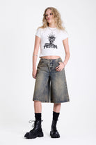Dirty wash longline oversized denim jorts with no waistband and silver latch clasp detail, worn by model