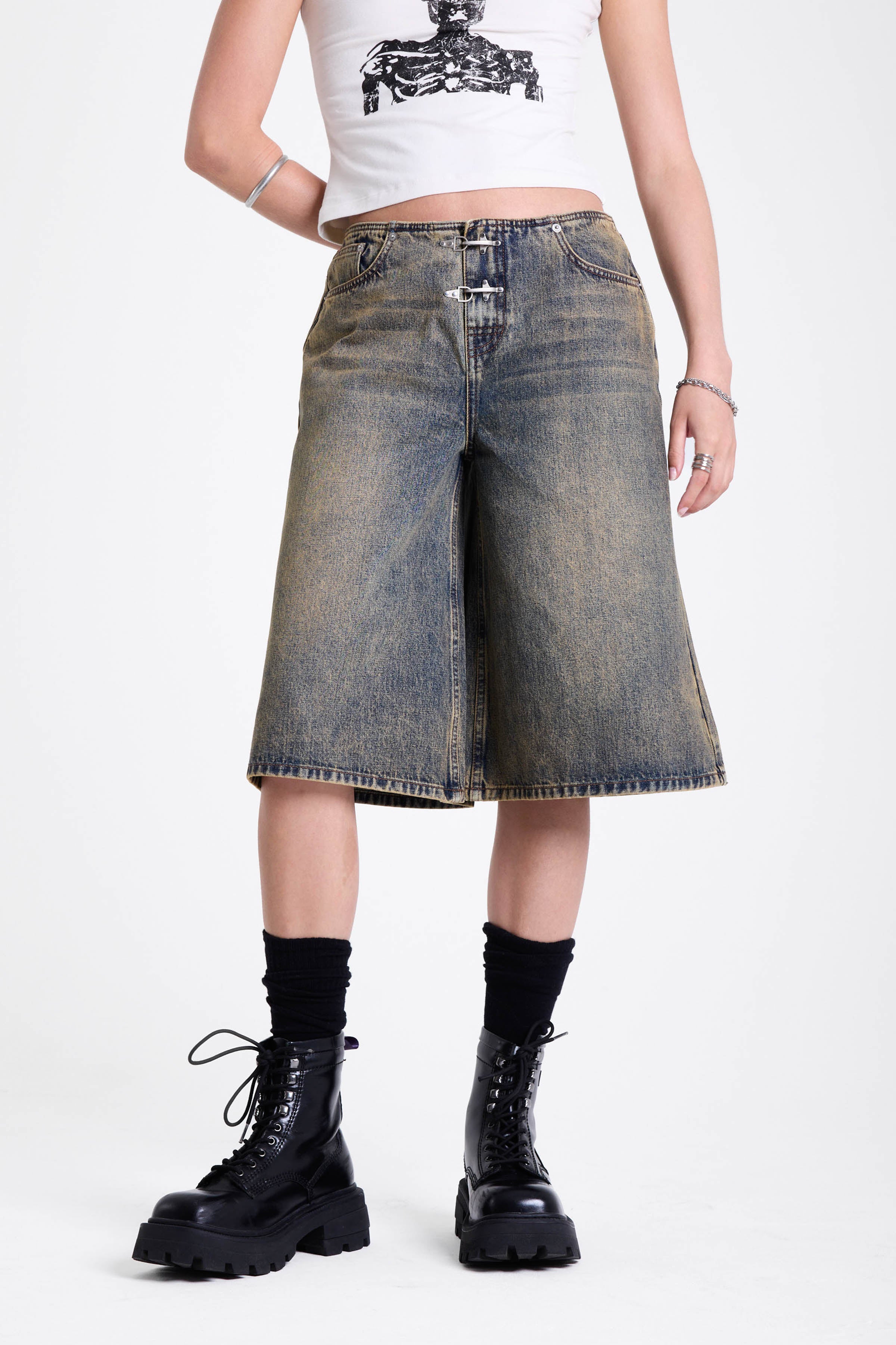 Dirty wash longline oversized denim jorts with no waistband and silver latch clasp detail, worn by model