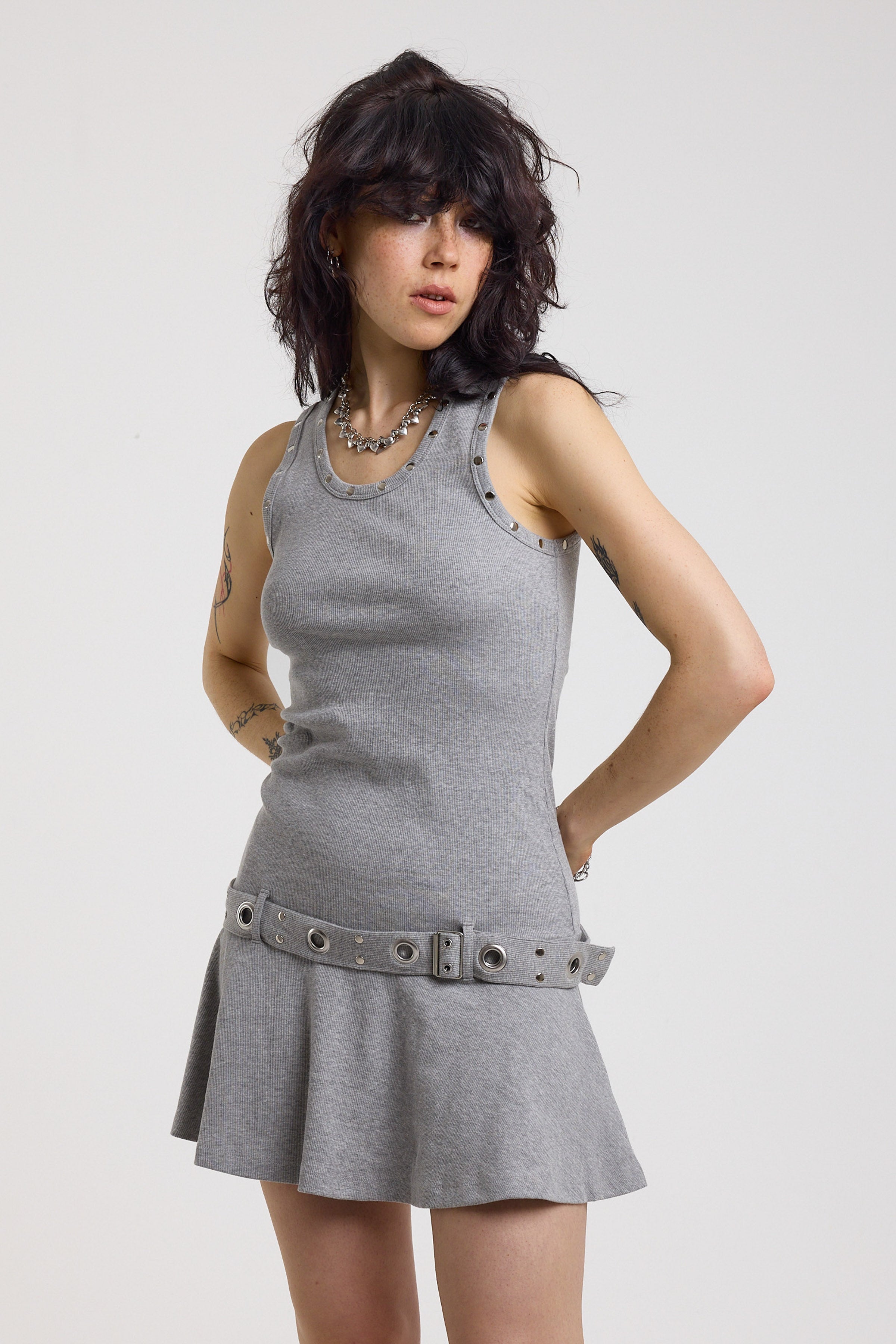 Grey mini dress with silver stud detail and eyelet detail belt, worn by model