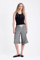 Green and yellow gingham longline boxer shorts, relaxed capri pants, with elasticated waistband and ruffle hem, worn by model