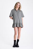 Green and yellow check shirt style mini dress with buttons, collar and peplum hem, worn by model