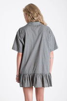 Green and yellow check shirt style mini dress with buttons, collar and peplum hem, worn by model