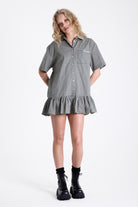 Green and yellow check shirt style mini dress with buttons, collar and peplum hem, worn by model