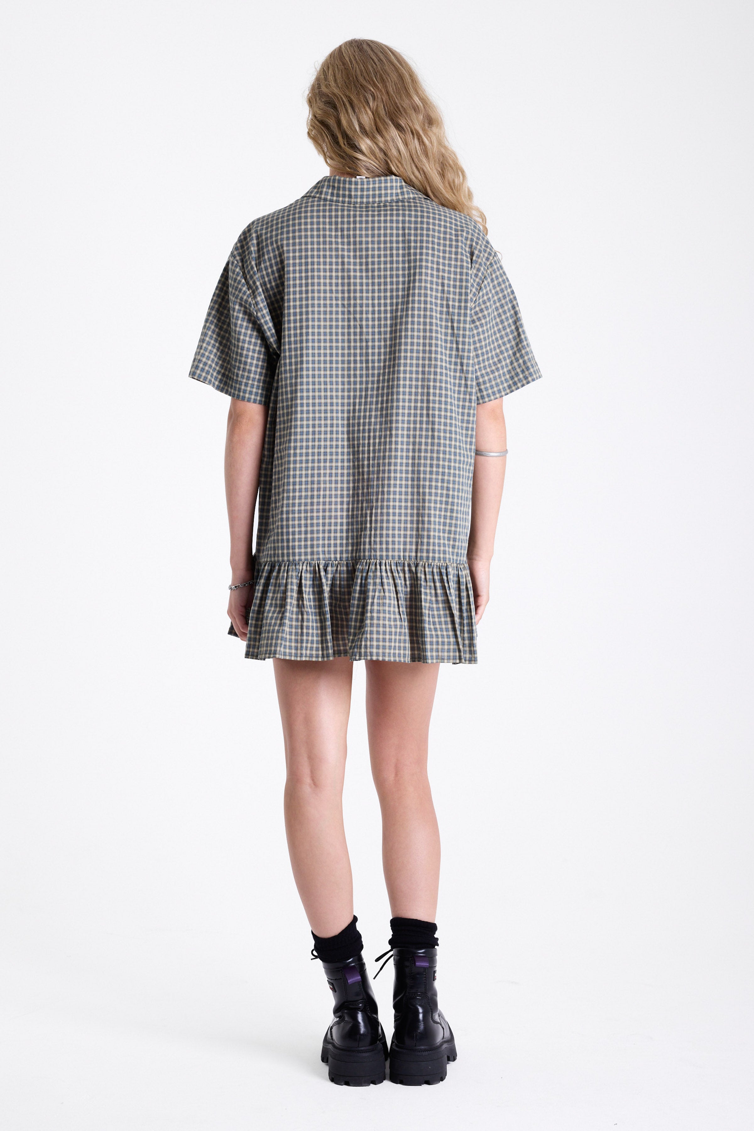 Green and yellow check shirt style mini dress with buttons, collar and peplum hem, worn by model