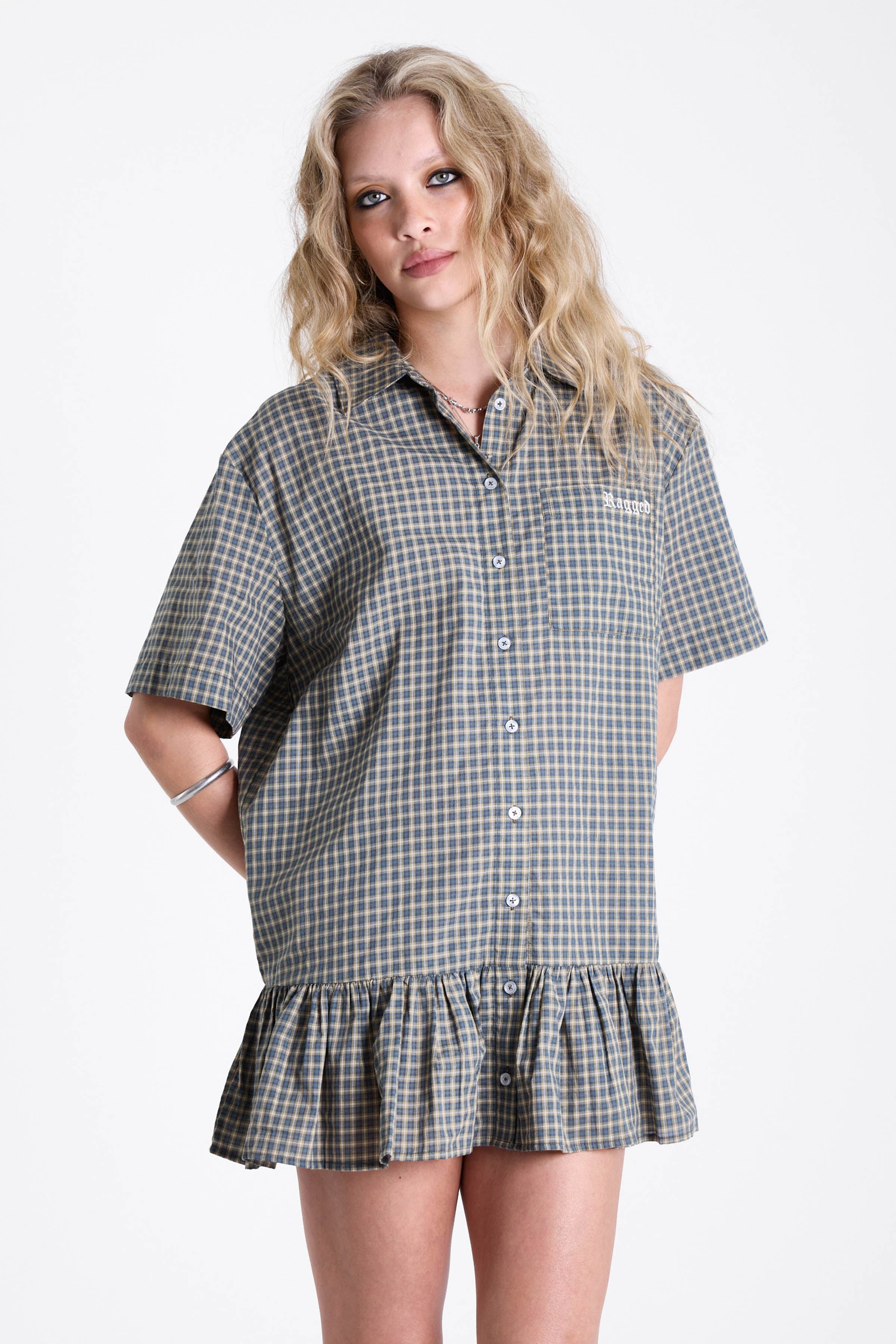 Green and yellow check shirt style mini dress with buttons, collar and peplum hem, worn by model