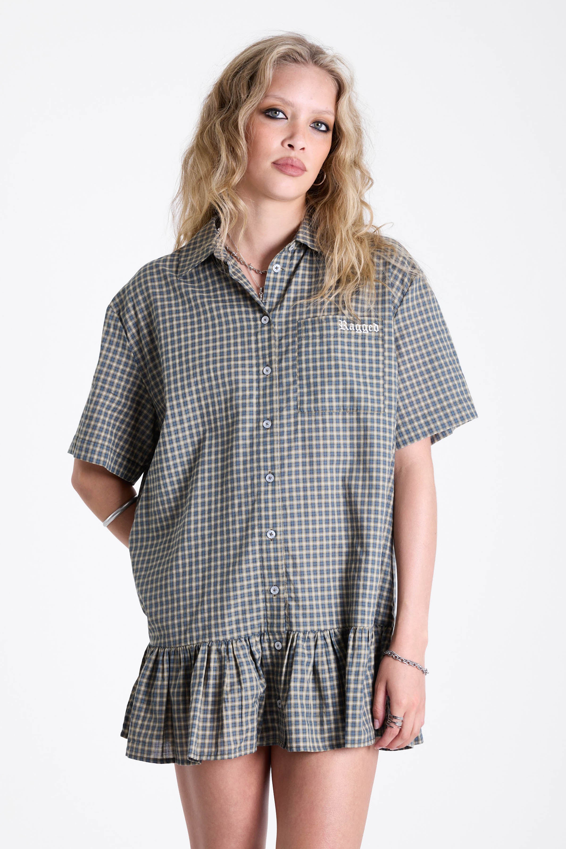 Green and yellow check shirt style mini dress with buttons, collar and peplum hem, worn by model