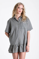 Green and yellow check shirt style mini dress with buttons, collar and peplum hem, worn by model