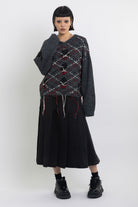 Grey argyle check knit jumper with cut outs and distressed details, worn by model