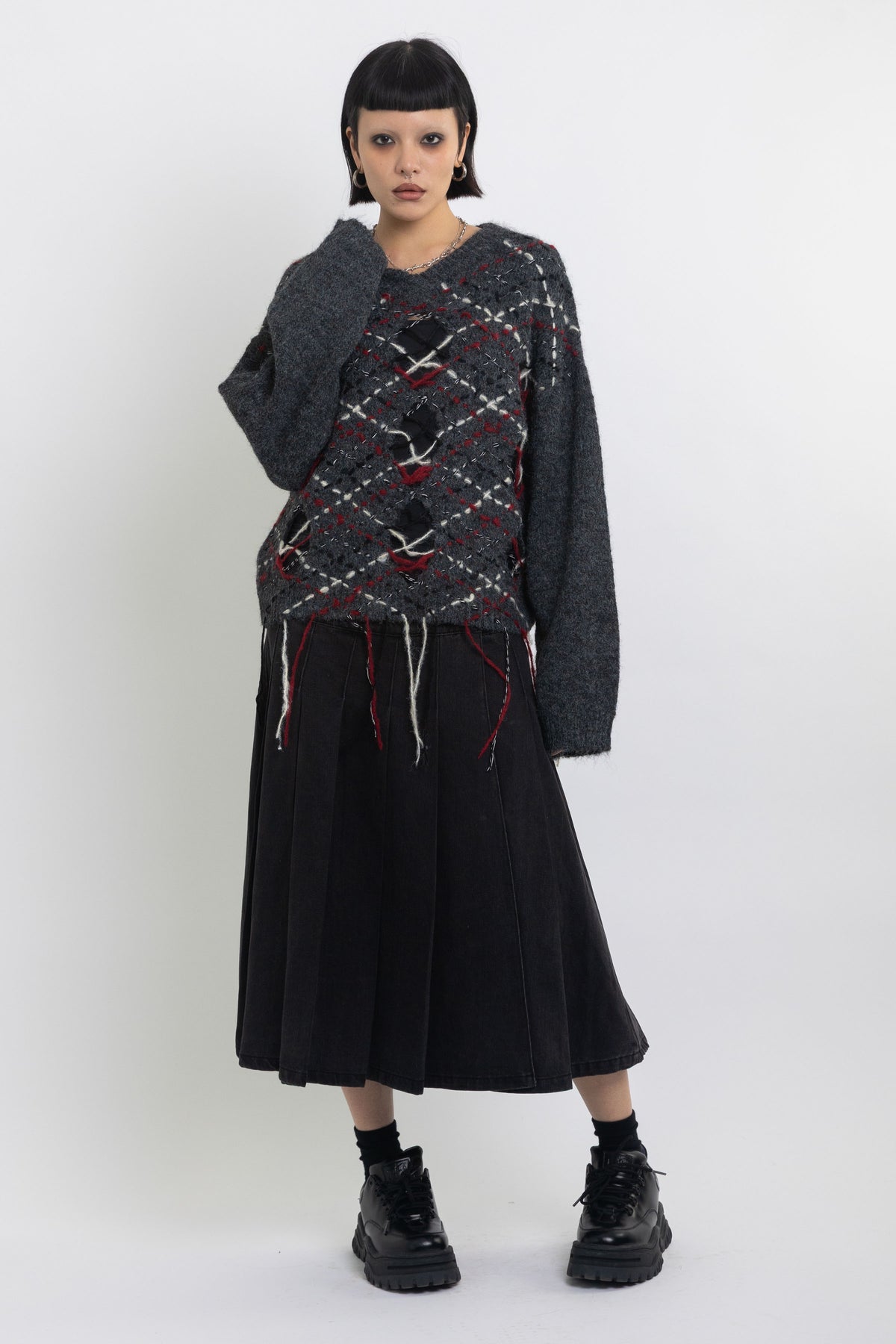 Grey argyle check knit jumper with cut outs and distressed details, worn by model
