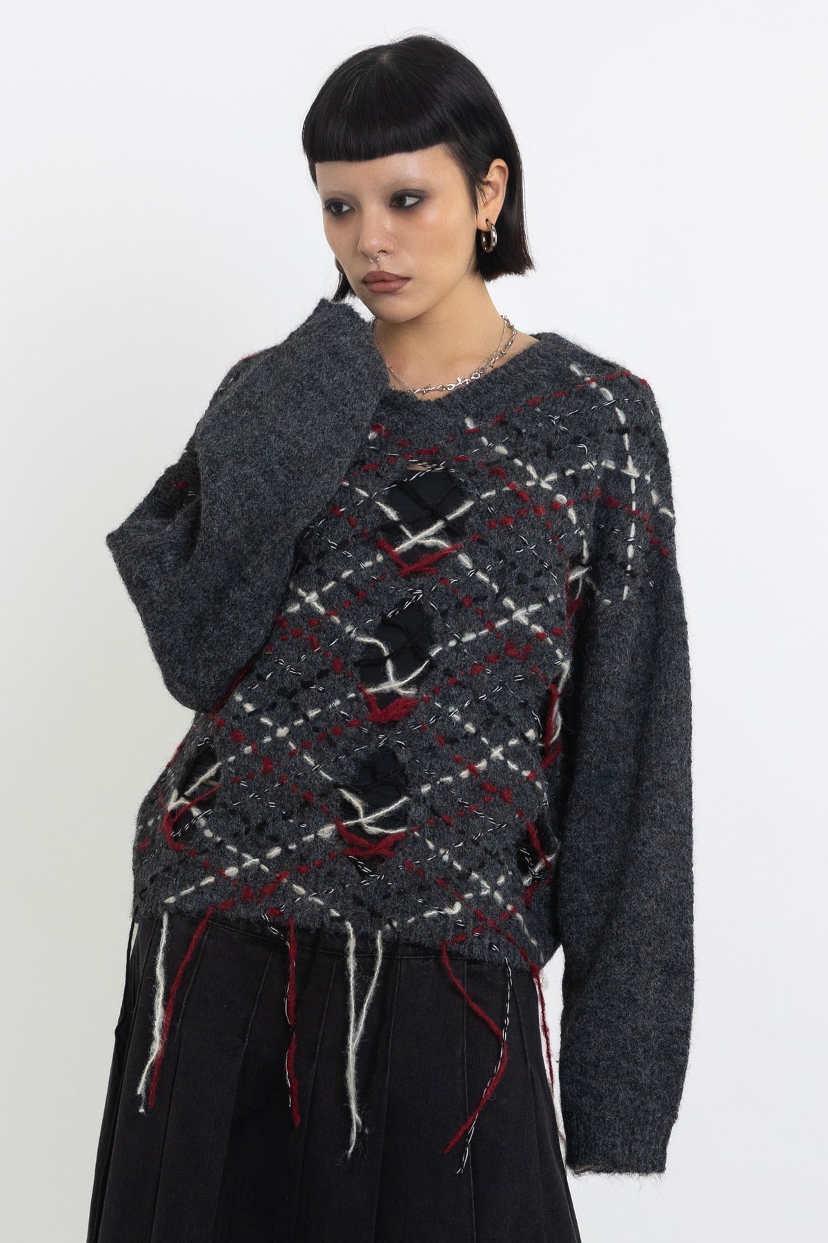 Grey argyle check knit jumper with cut outs and distressed details, worn by model