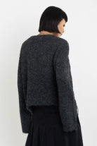 Grey argyle check knit jumper with cut outs and distressed details, worn by model