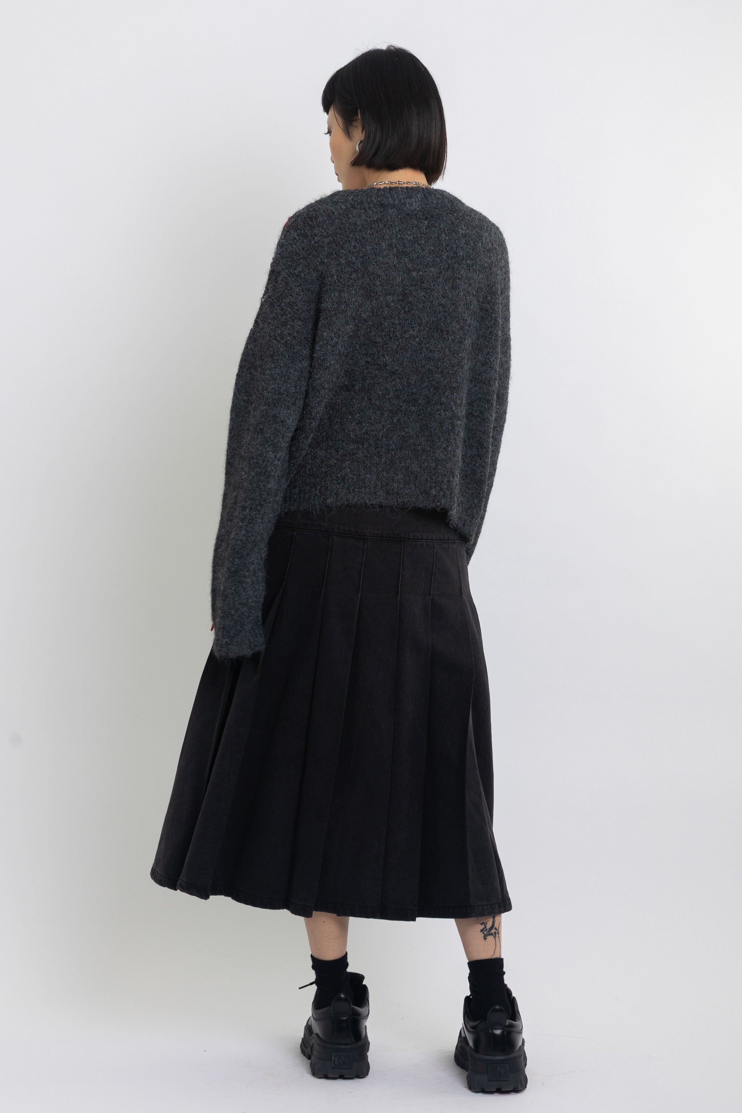 Grey argyle check knit jumper with cut outs and distressed details, worn by model
