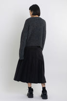 Grey argyle check knit jumper with cut outs and distressed details, worn by model