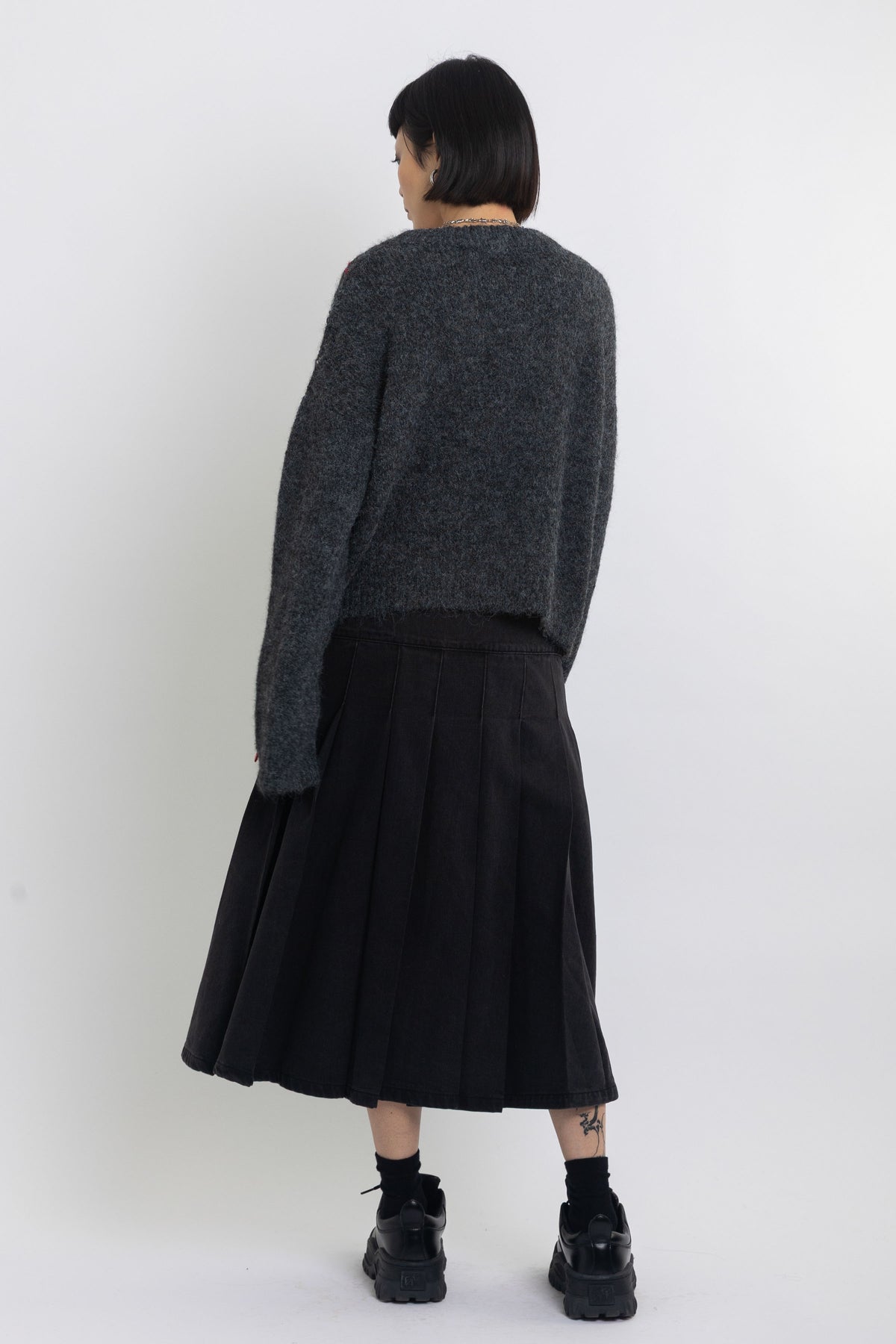 Grey argyle check knit jumper with cut outs and distressed details, worn by model