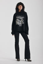 Black oversized knit jumper with skeleton graphic print, worn by model