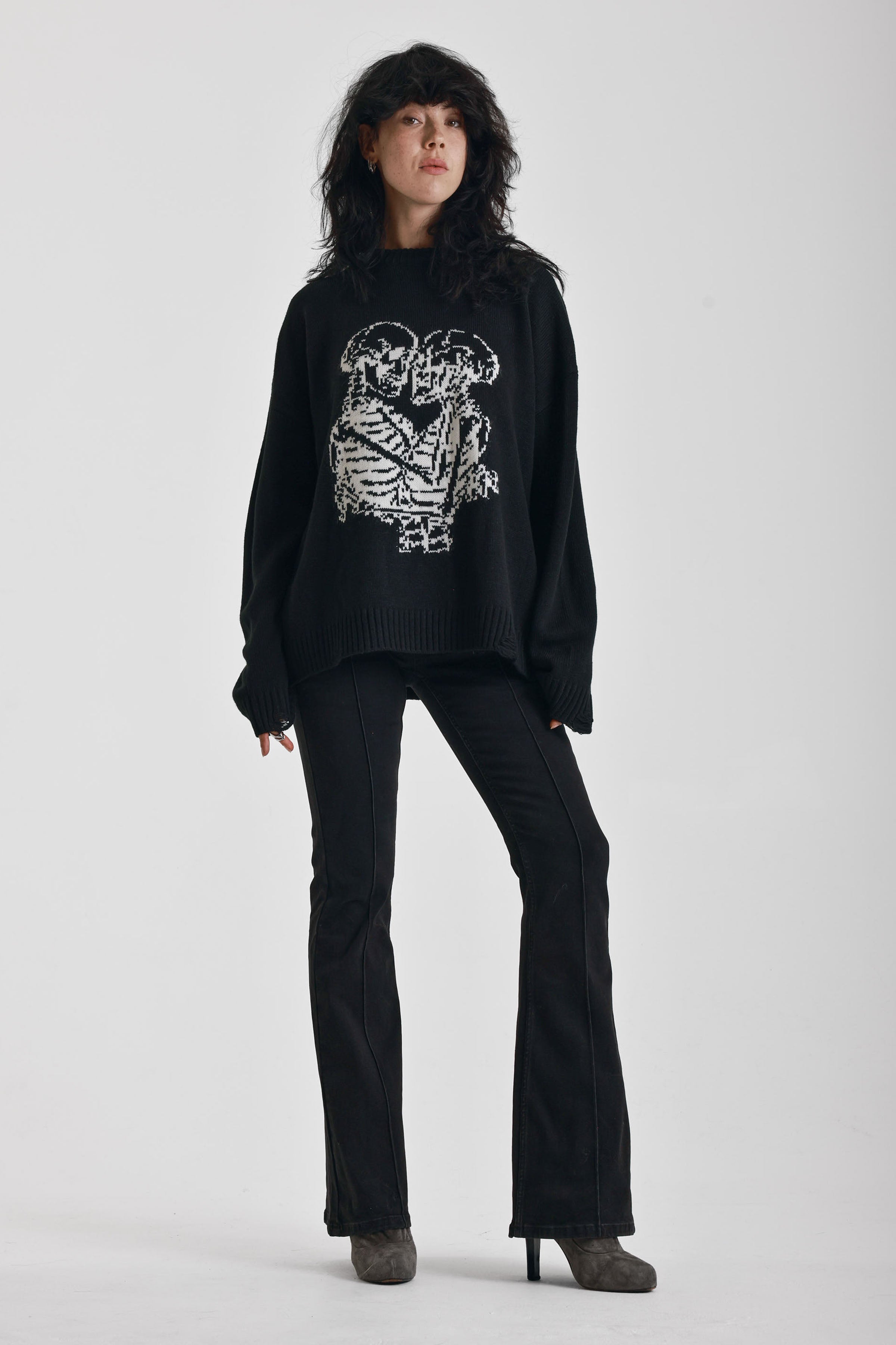 Black oversized knit jumper with skeleton graphic print, worn by model