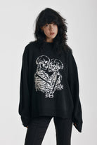 Black oversized knit jumper with skeleton graphic print, worn by model