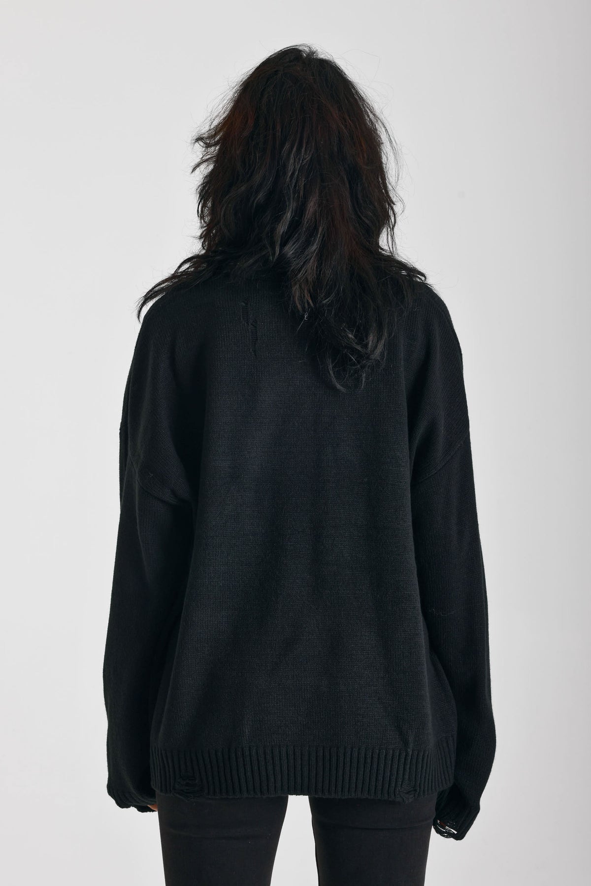 Black oversized knit jumper with skeleton graphic print, worn by model