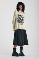 Cream oversized knit jumper with skeleton graphic, worn by model