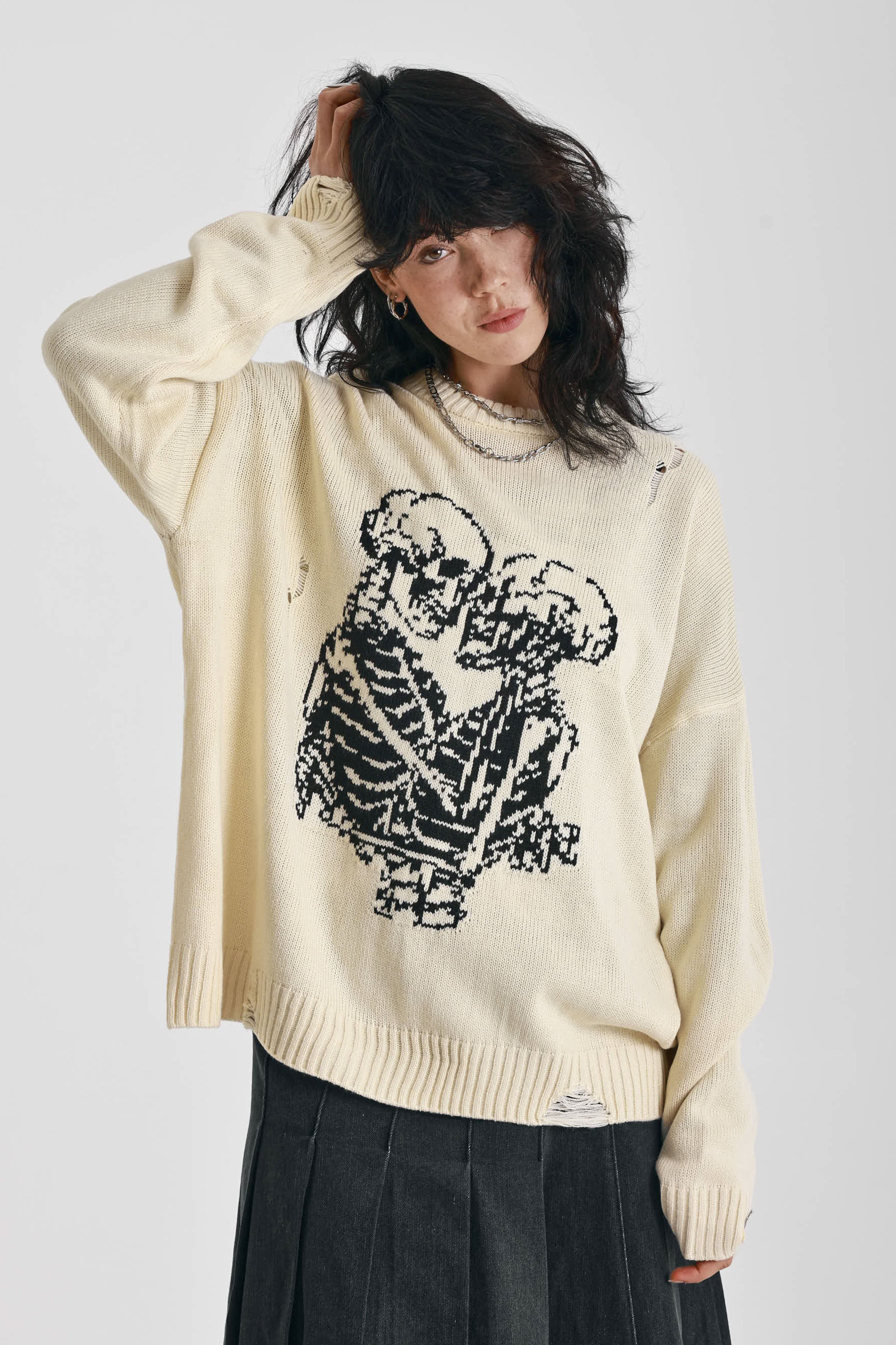 Cream oversized knit jumper with skeleton graphic, worn by model