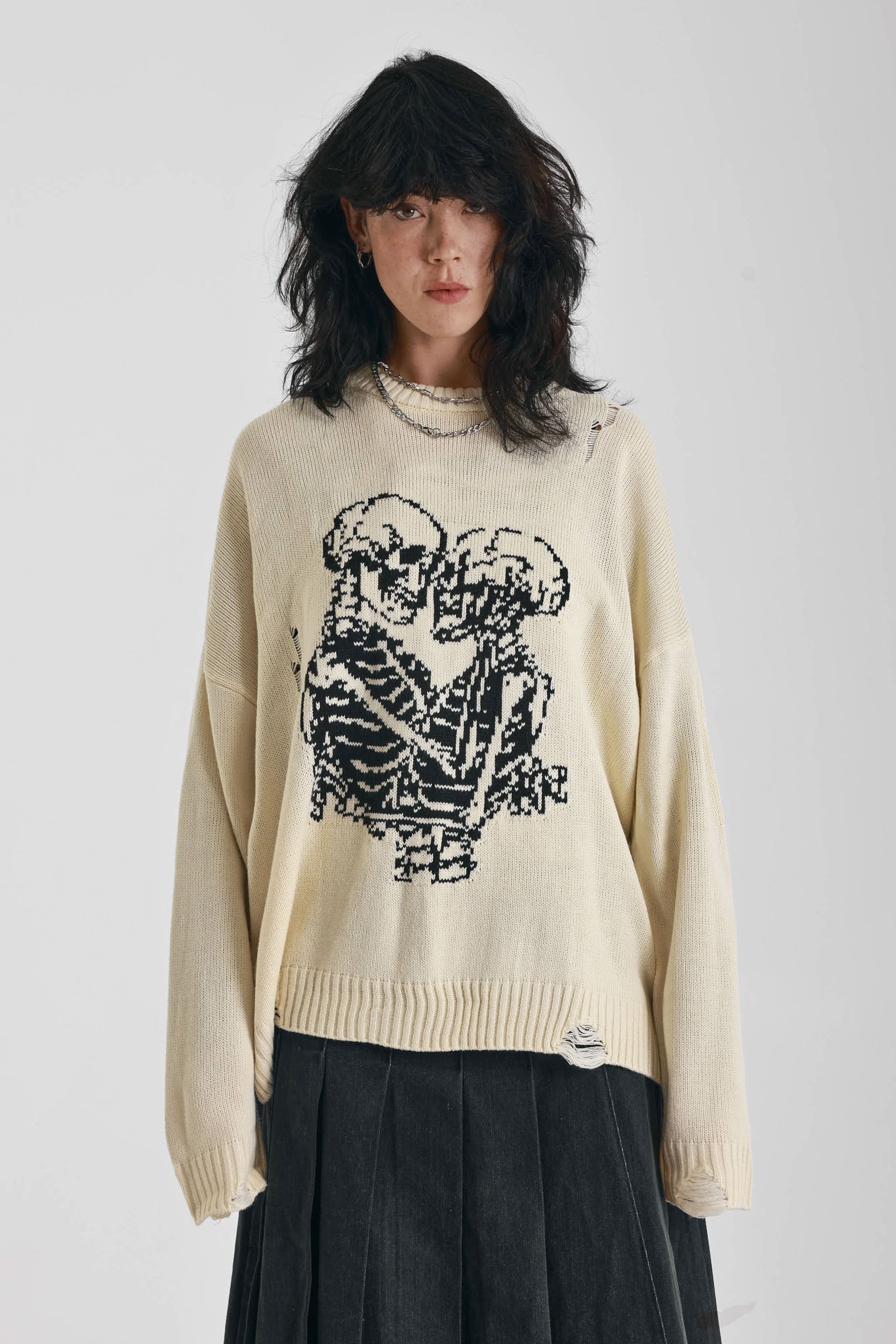 Cream oversized knit jumper with skeleton graphic, worn by model
