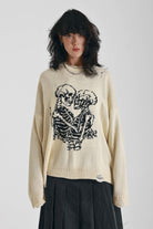 Cream oversized knit jumper with skeleton graphic, worn by model
