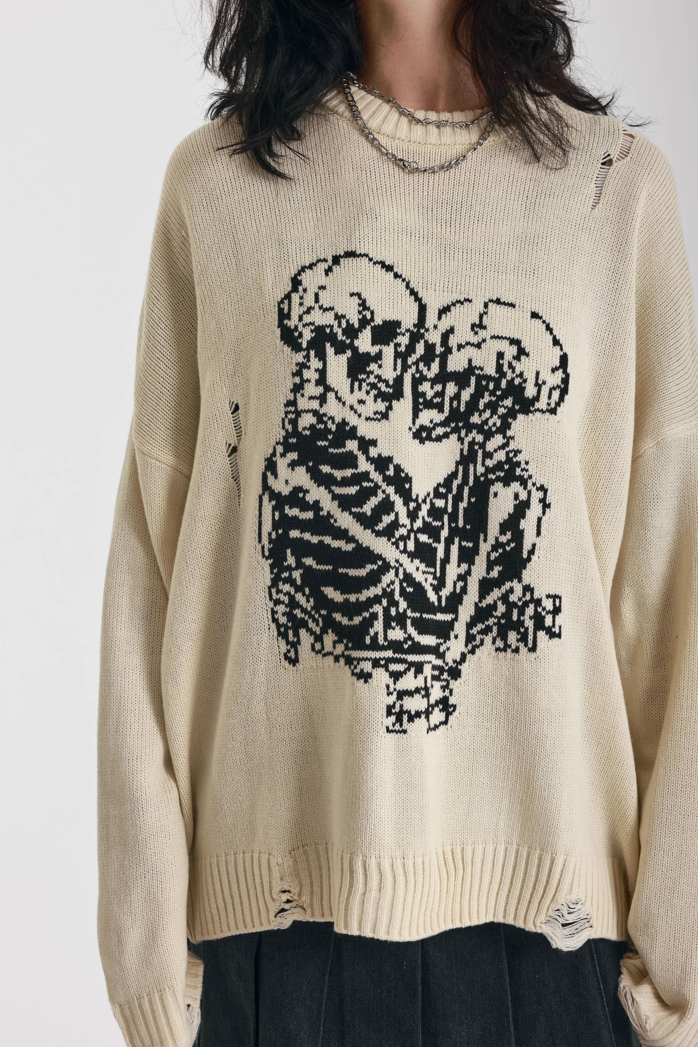 Cream oversized knit jumper with skeleton graphic, worn by model