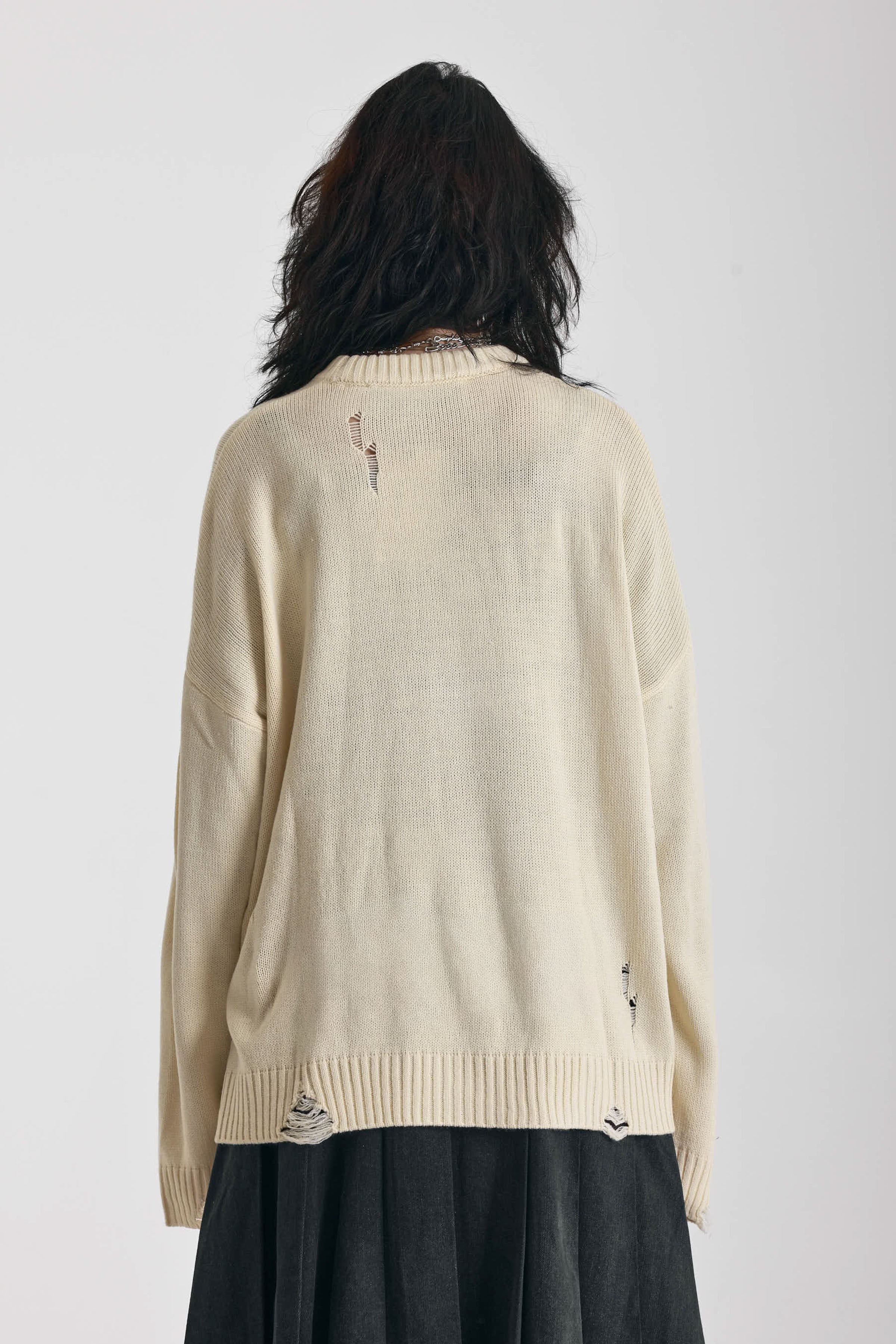 Cream oversized knit jumper with skeleton graphic, worn by model