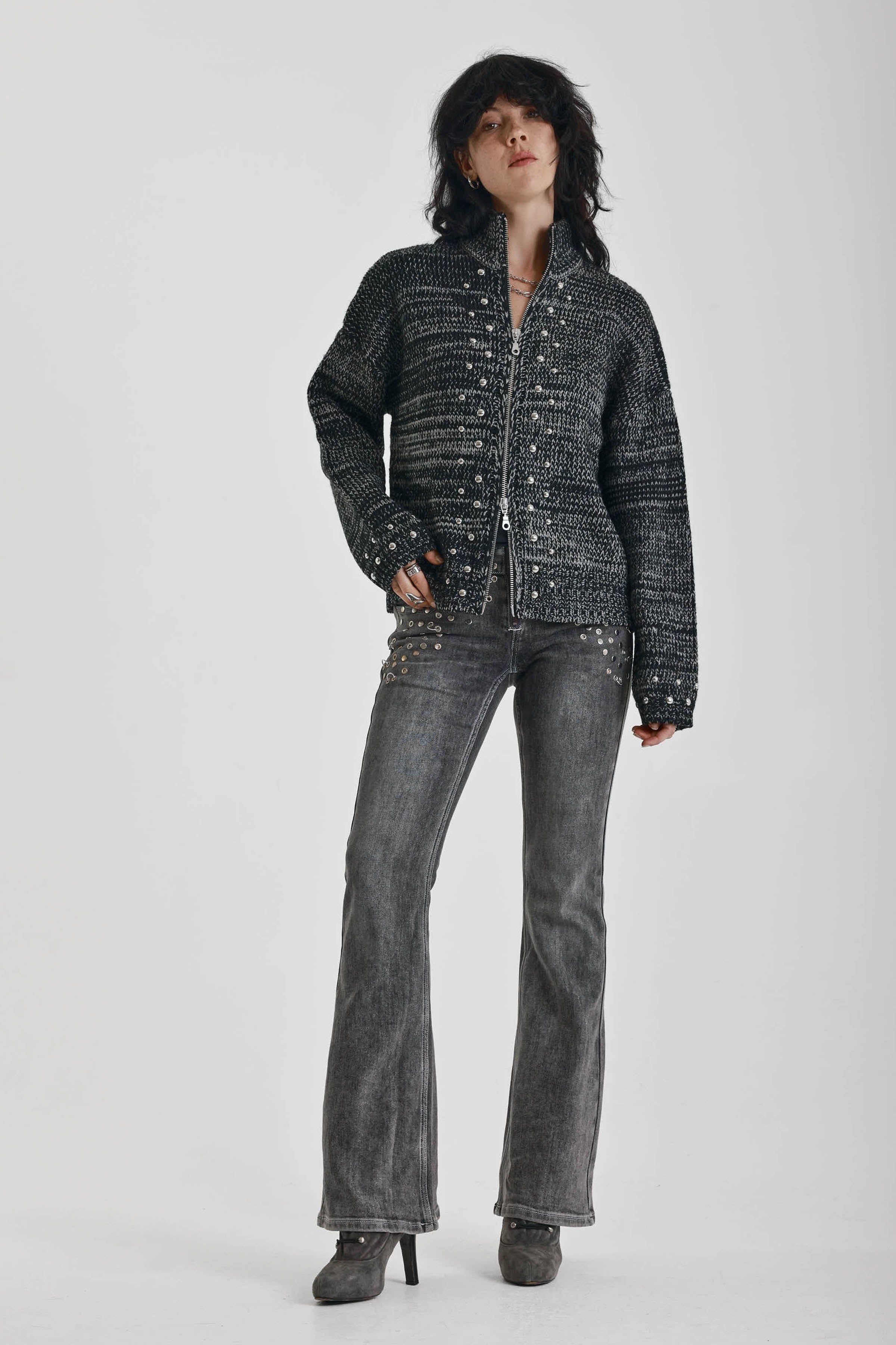 Black and grey chunky spacedye knit zip through cardigan with silver studs, worn by model