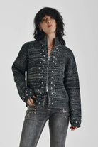 Black and grey chunky spacedye knit zip through cardigan with silver studs, worn by model
