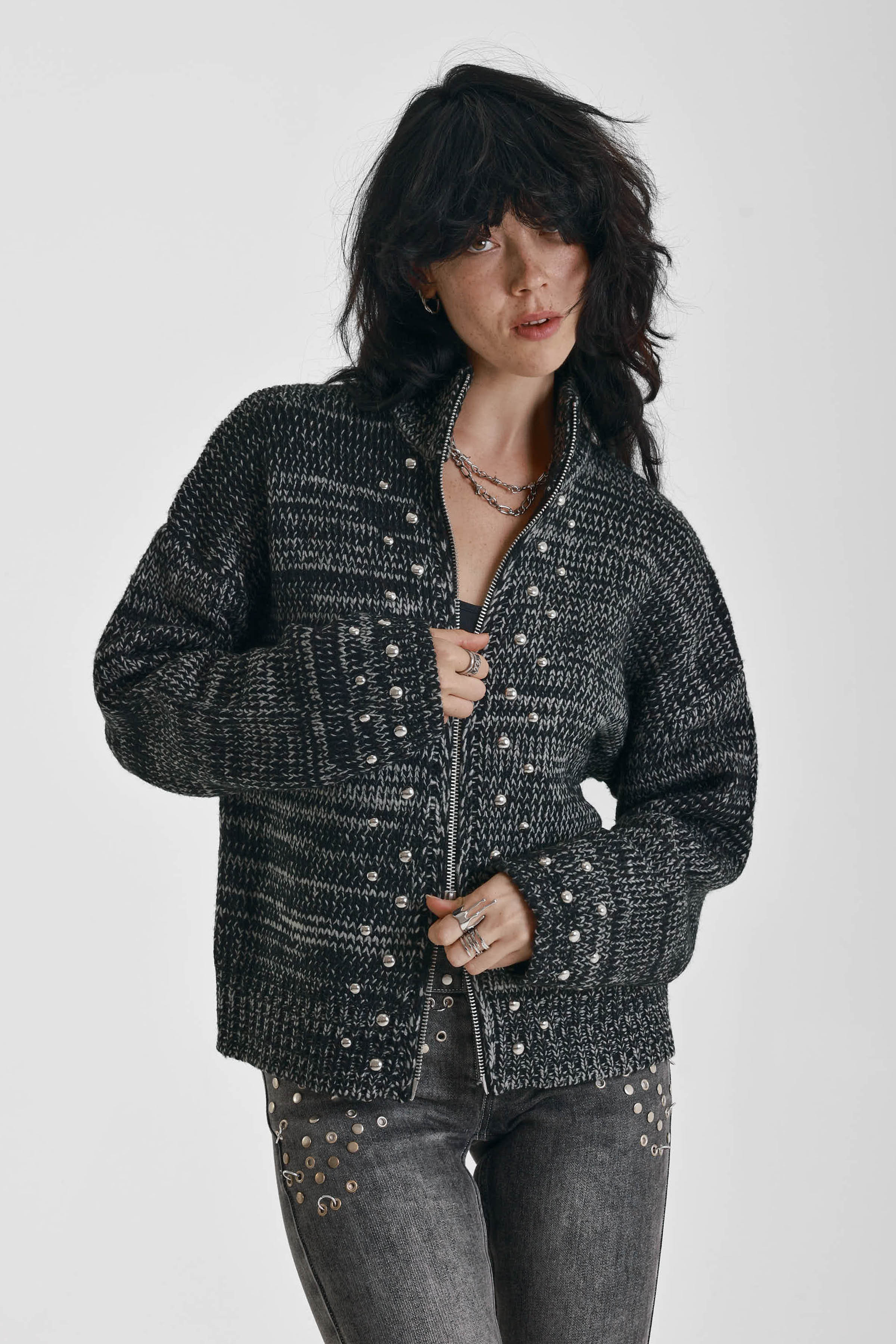 Black and grey chunky spacedye knit zip through cardigan with silver studs, worn by model