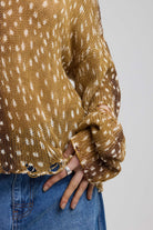 Brown deer print oversized knit jumper with grunge distressed details, worn by model