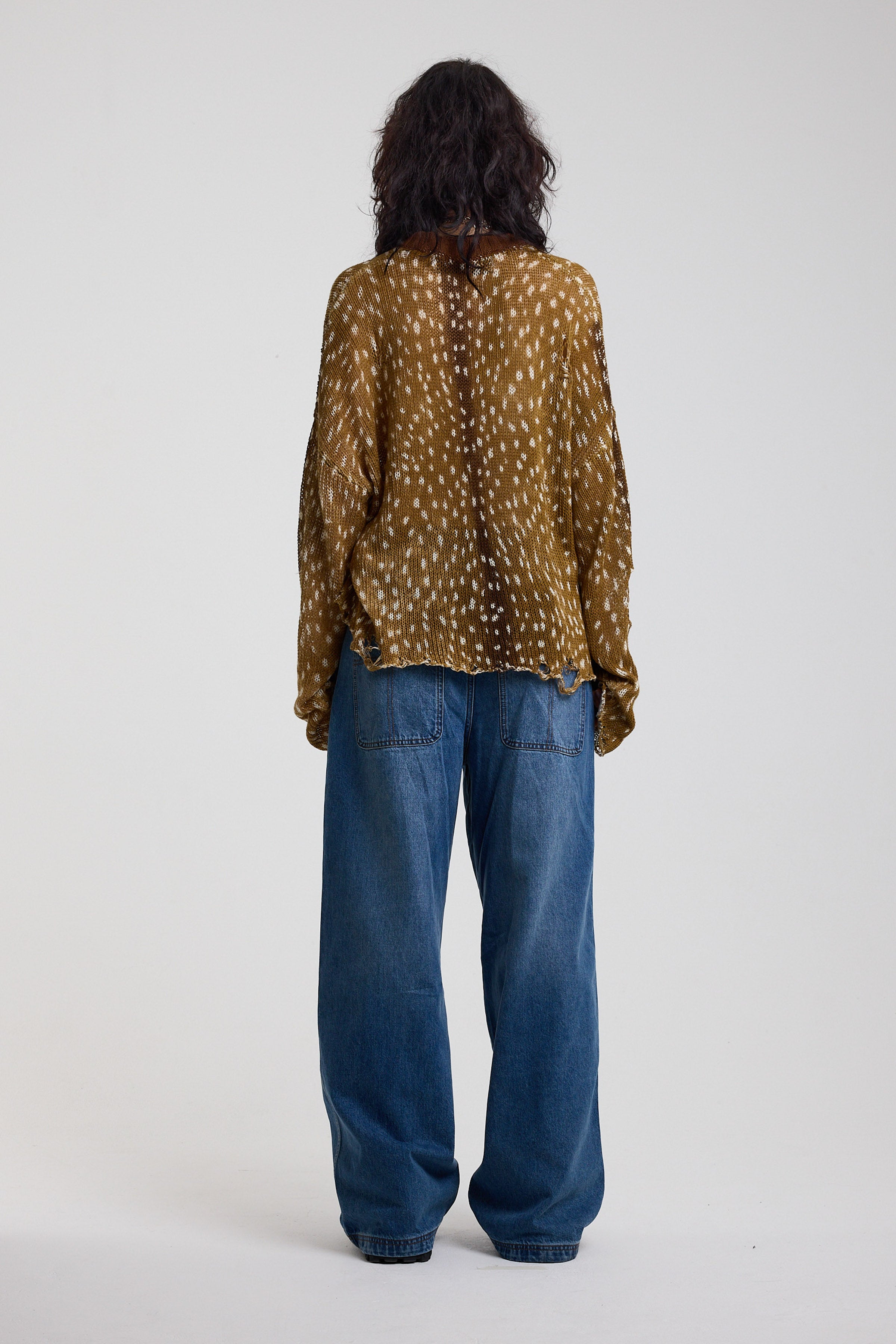 Back of brown deer print oversized knit jumper with grunge distressed details, worn by model