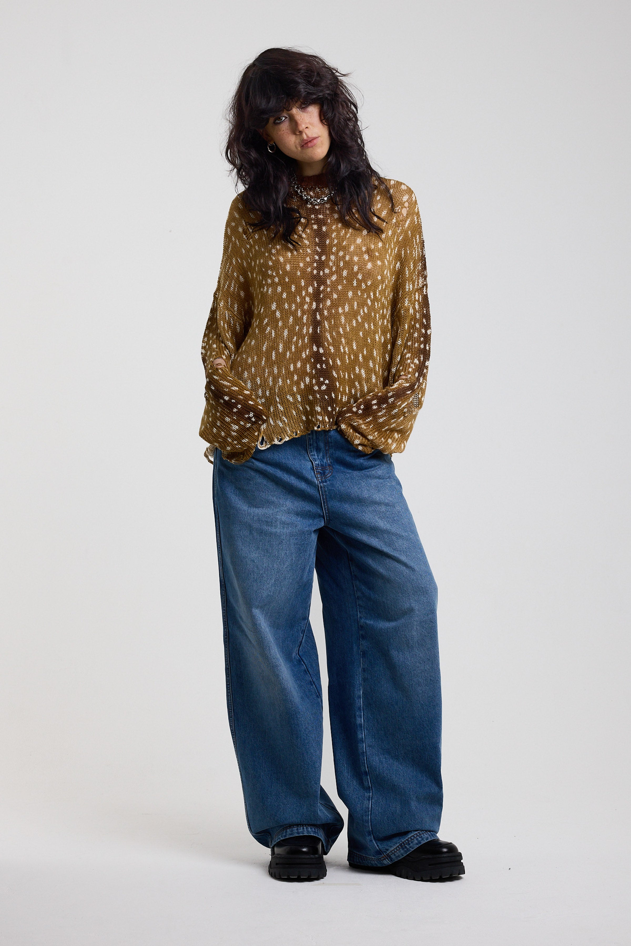 Brown deer print oversized knit jumper with grunge distressed details, worn by model