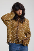 Brown deer print oversized knit jumper with grunge distressed details, worn by model