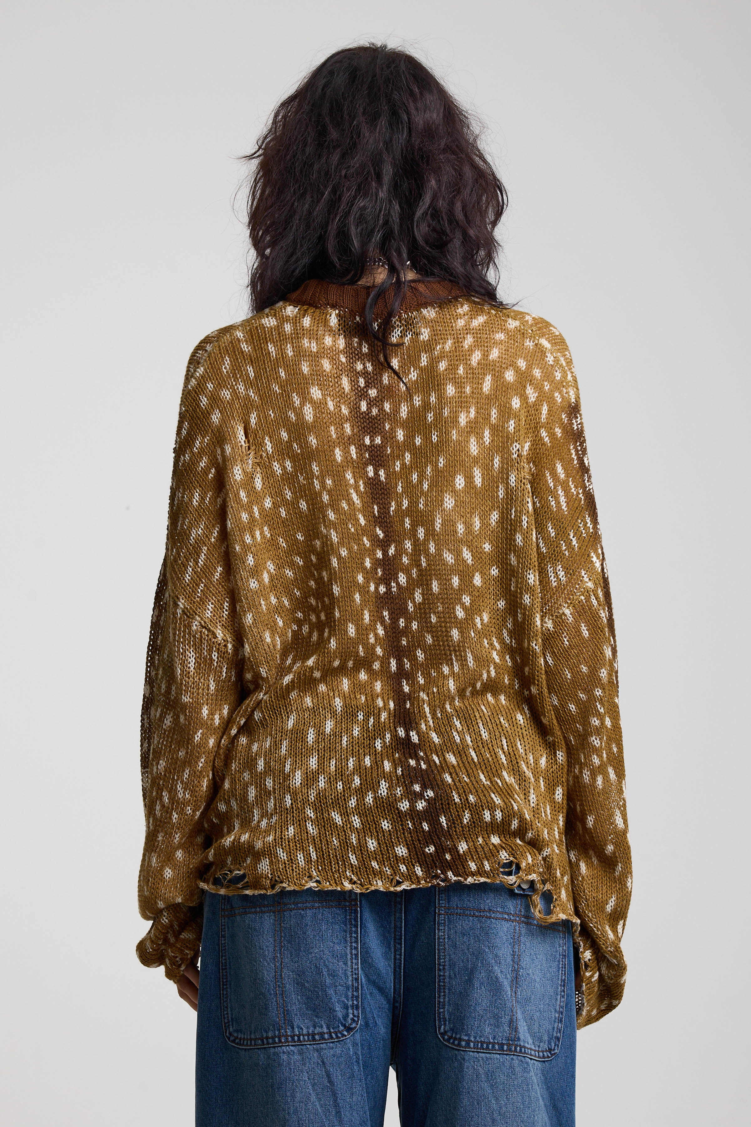 Back of brown deer print oversized knit jumper with grunge distressed details, worn by model