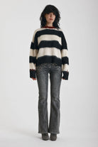 Black and white stripe fluffy knit jumper with burgundy crew neck, worn by model
