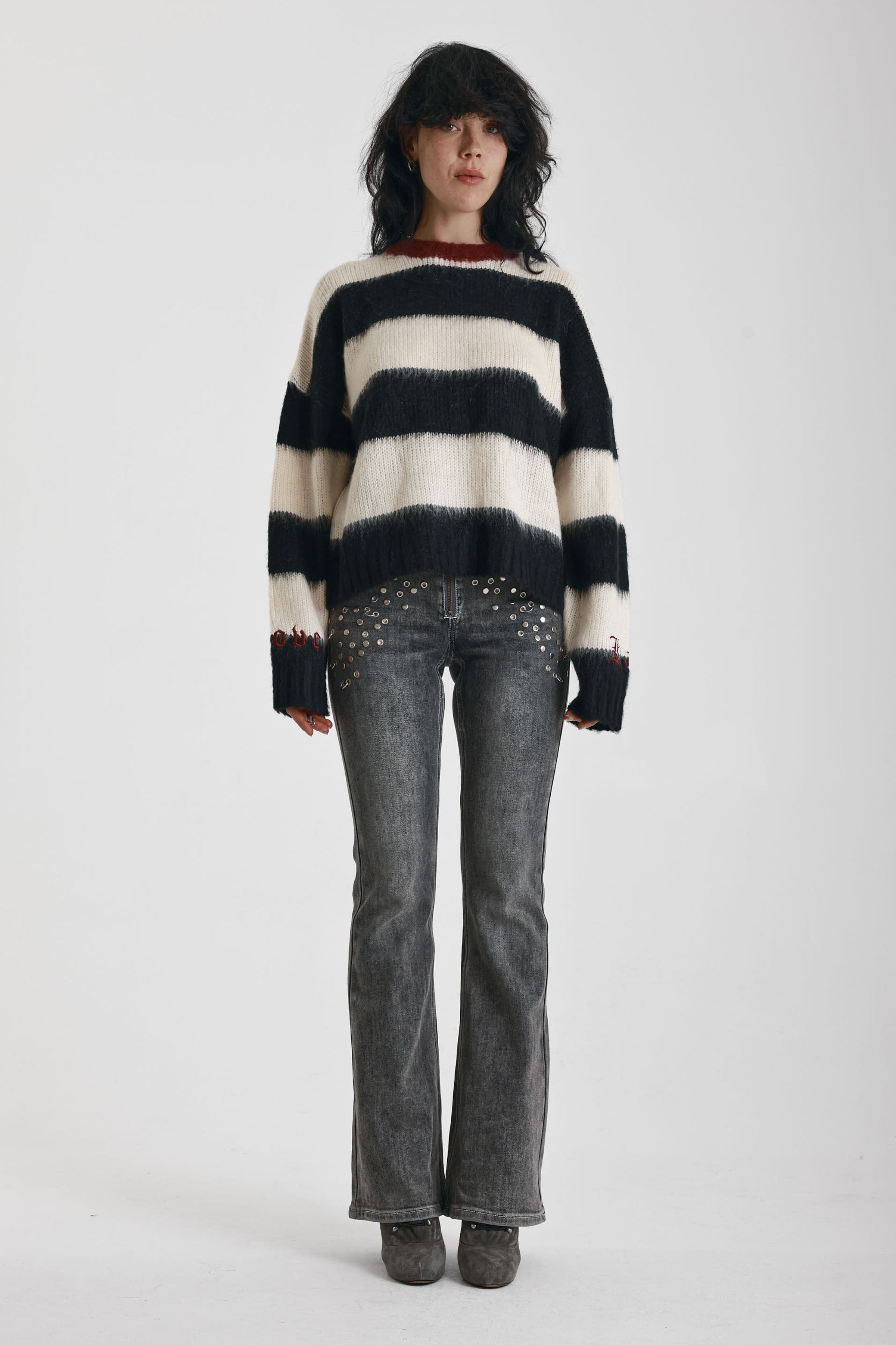 Black and white stripe fluffy knit jumper with burgundy crew neck, worn by model
