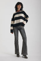 Black and white stripe fluffy knit jumper with burgundy crew neck, worn by model