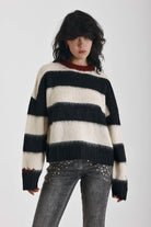 Black and white stripe fluffy knit jumper with burgundy crew neck, worn by model