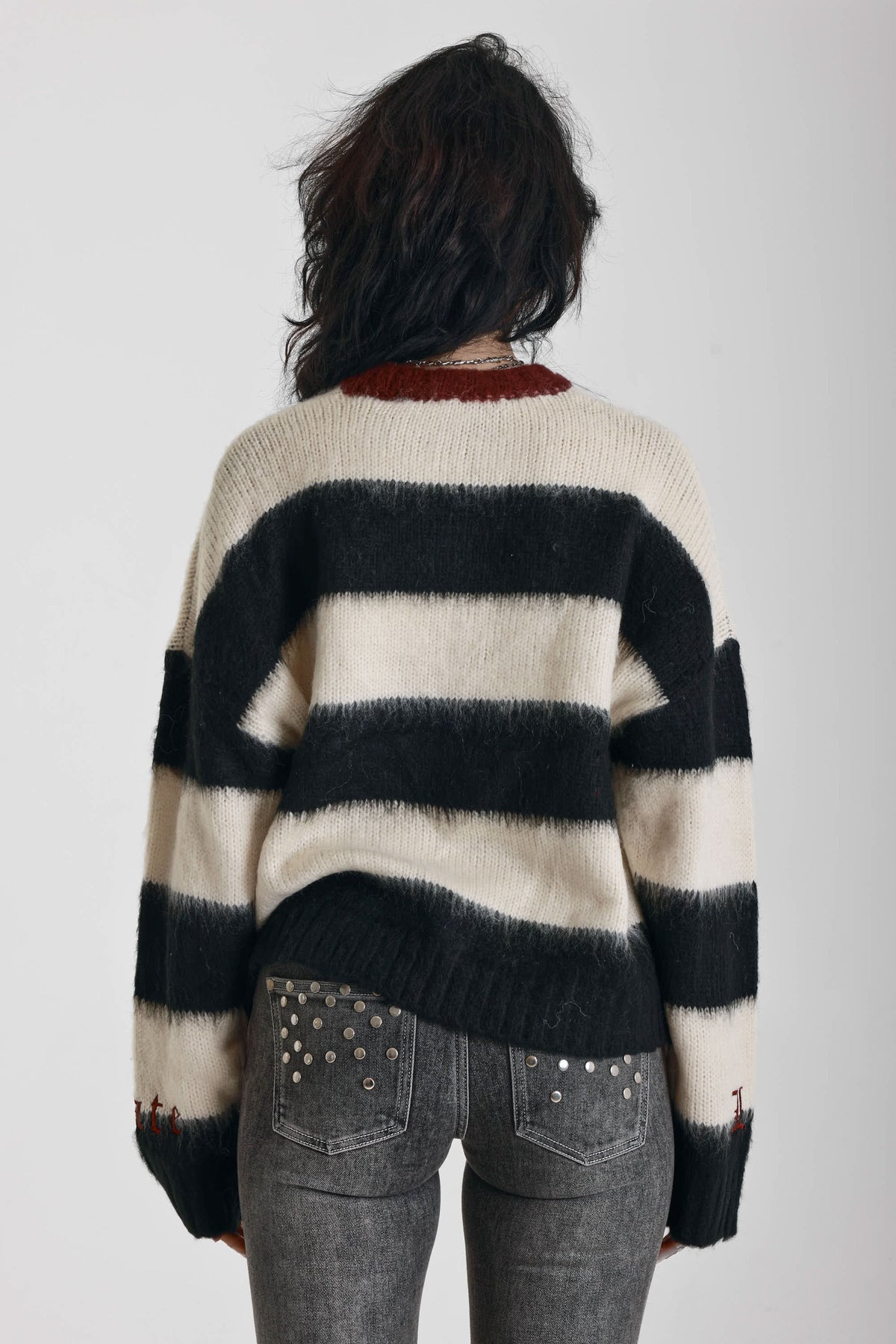 Black and white stripe fluffy knit jumper with burgundy crew neck, worn by model